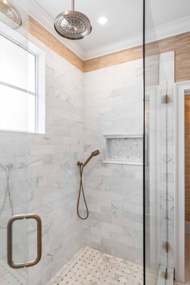 bathroom featuring crown molding and an enclosed shower