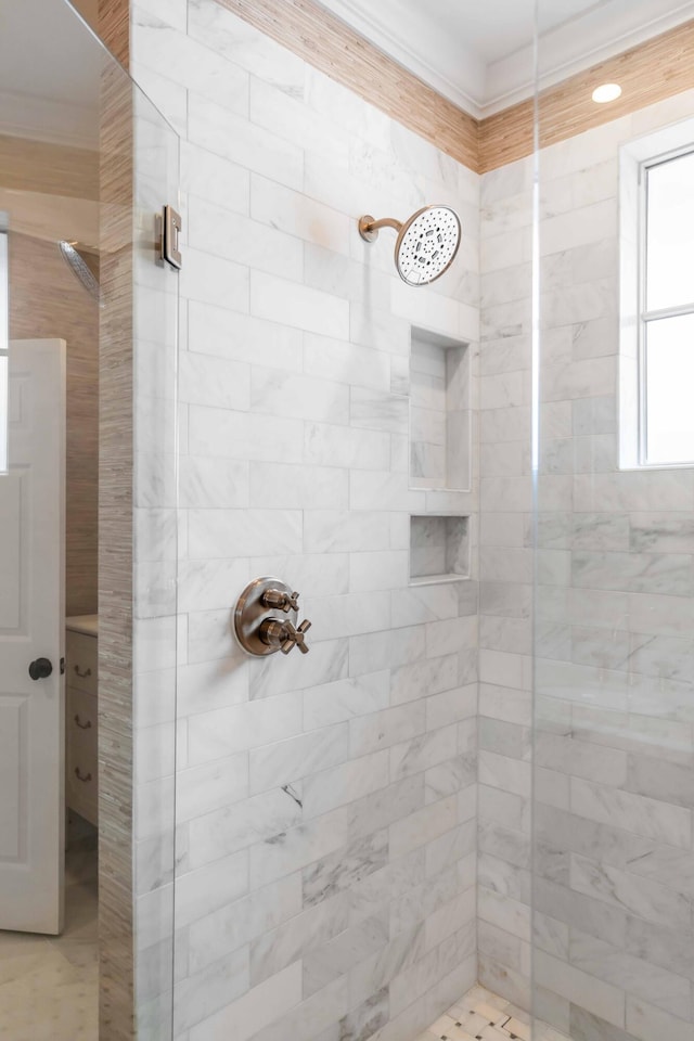 bathroom featuring a shower with door