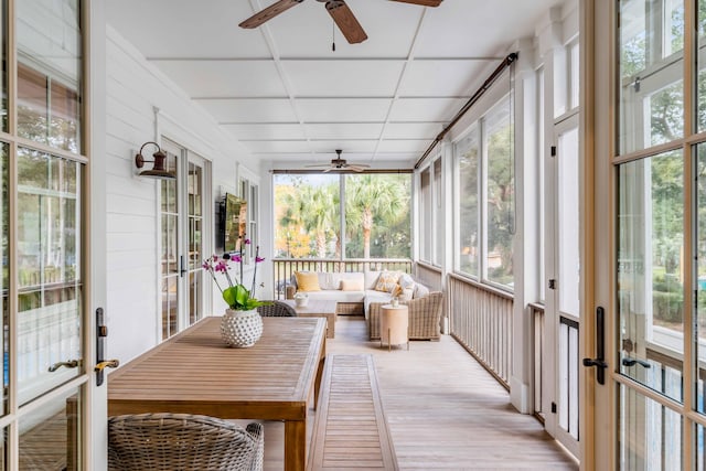 sunroom featuring french doors, a drop ceiling, and ceiling fan