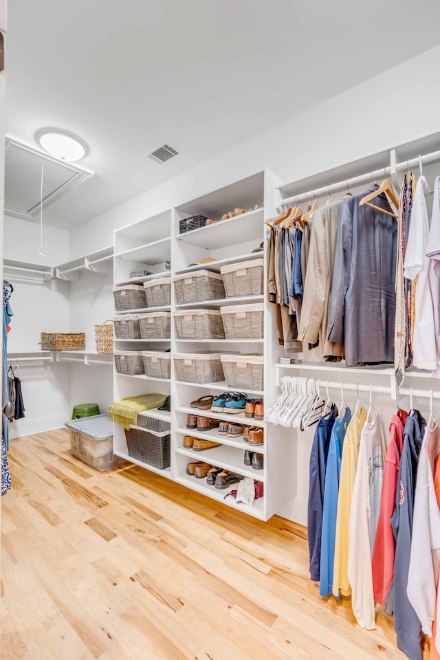 walk in closet with hardwood / wood-style floors