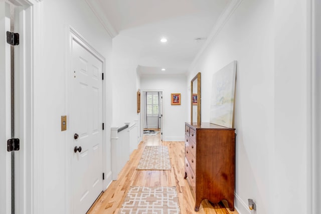 corridor featuring ornamental molding and light wood-type flooring