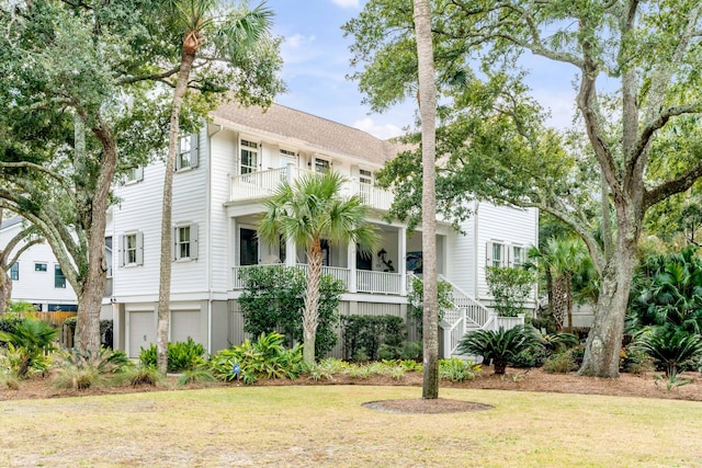 view of front of house with a front yard and a garage