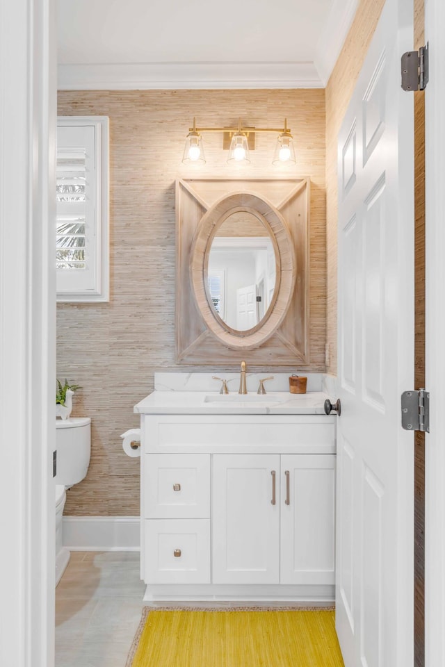 bathroom featuring crown molding, vanity, and toilet