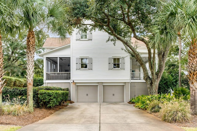 view of front facade with a garage and a sunroom