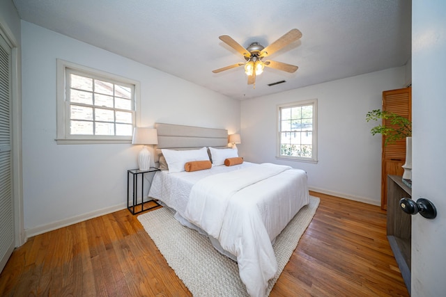 bedroom with hardwood / wood-style floors and ceiling fan