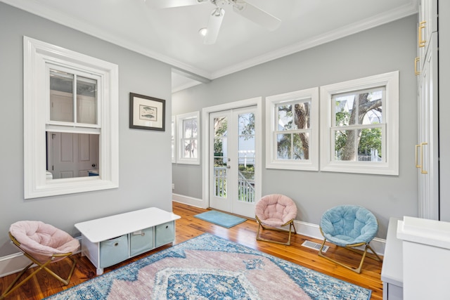 sitting room featuring wood-type flooring, ornamental molding, french doors, and ceiling fan