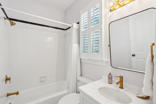 full bathroom with shower / tub combo with curtain, vanity, a wealth of natural light, and toilet