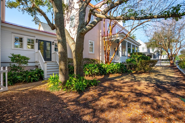 view of property exterior featuring covered porch