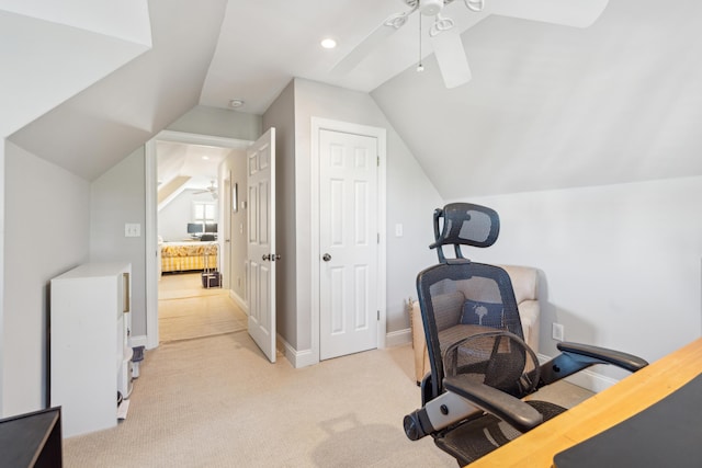 carpeted office space with ceiling fan and vaulted ceiling