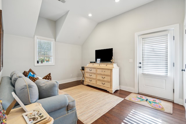 living room featuring lofted ceiling and dark hardwood / wood-style flooring