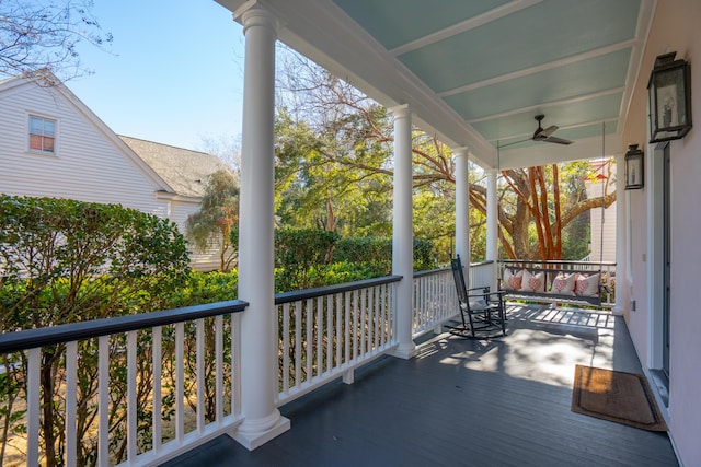 wooden deck featuring ceiling fan and a porch