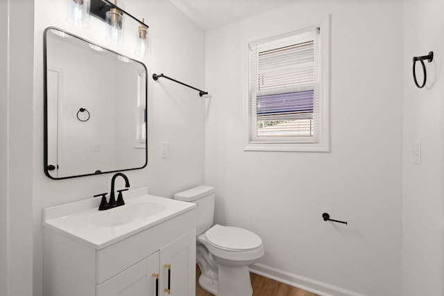 bathroom featuring hardwood / wood-style floors, vanity, and toilet