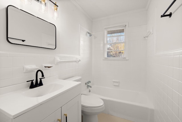 full bathroom with vanity, crown molding, tiled shower / bath, toilet, and tile walls