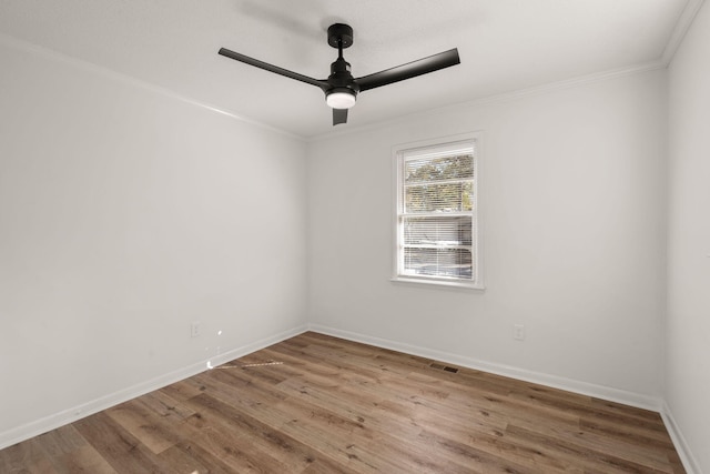 empty room with hardwood / wood-style flooring, ceiling fan, and crown molding