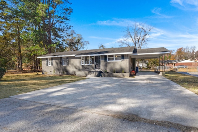 ranch-style home with a carport and a front lawn