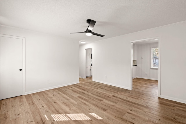 spare room with ceiling fan, crown molding, a textured ceiling, and light hardwood / wood-style flooring