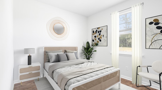 bedroom featuring baseboards and wood finished floors