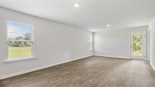 spare room featuring recessed lighting, visible vents, baseboards, and wood finished floors