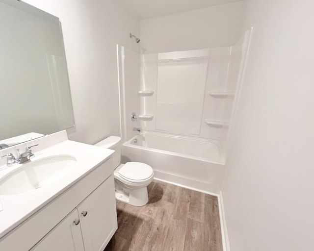 bathroom with shower / washtub combination, toilet, vanity, and wood finished floors