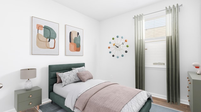 bedroom with wood finished floors and baseboards