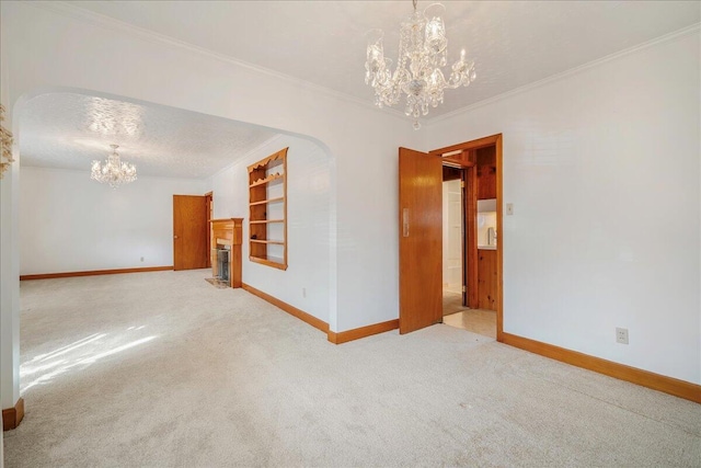 2830 Wire Rd, Saint George, SC 29477 - spare room with a textured ceiling, ornamental molding, a chandelier, and carpet flooring