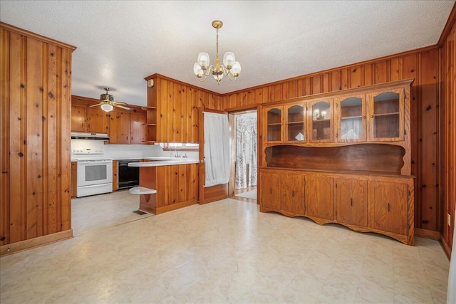 2830 Wire Rd, Saint George, SC 29477 - kitchen featuring dishwasher, pendant lighting, white electric range, and wooden walls