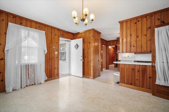 2830 Wire Rd, Saint George, SC 29477 - kitchen with ornamental molding, pendant lighting, kitchen peninsula, and wood walls