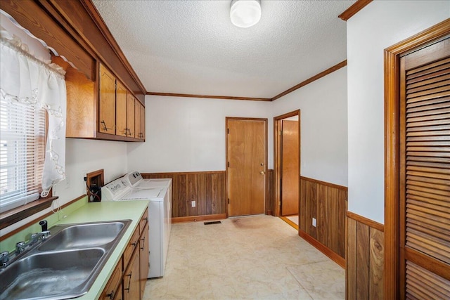 2830 Wire Rd, Saint George, SC 29477 - laundry area with wooden walls, sink, cabinets, crown molding, and a textured ceiling