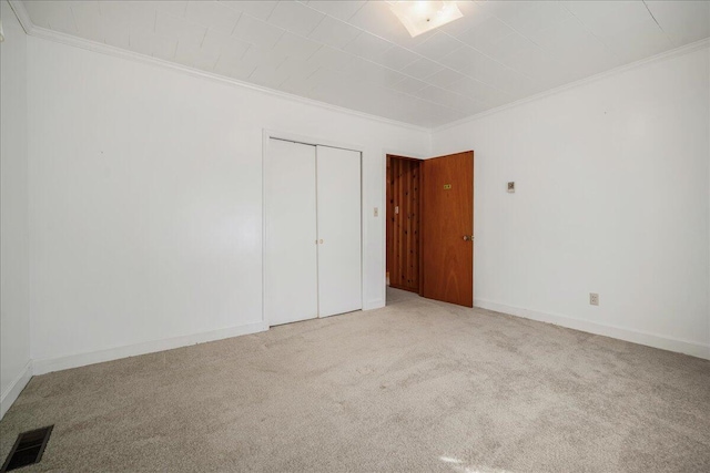 2830 Wire Rd, Saint George, SC 29477 - unfurnished bedroom with crown molding, a closet, and light carpet