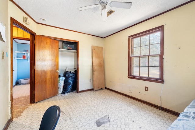 bedroom with ornamental molding, a textured ceiling, ceiling fan, and a closet