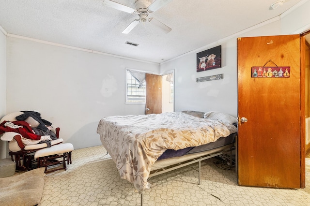 bedroom with ornamental molding, a textured ceiling, and ceiling fan