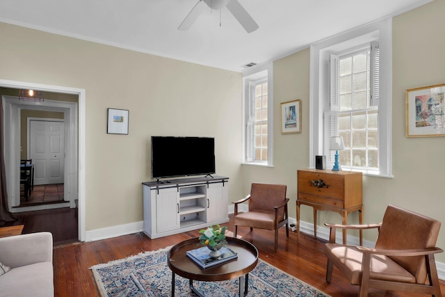 living room featuring dark wood-type flooring and ceiling fan