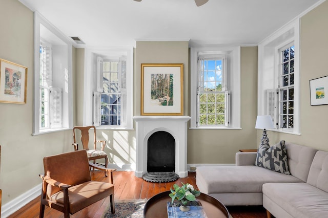 living room featuring crown molding and hardwood / wood-style floors