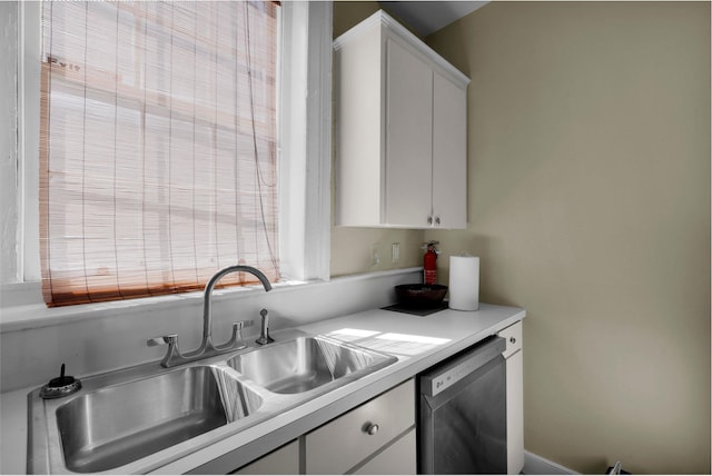 kitchen with sink, white cabinetry, and stainless steel dishwasher