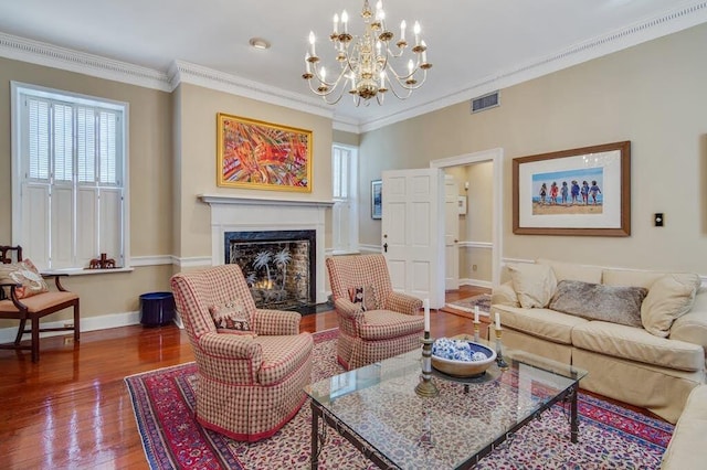 living room featuring ornamental molding, a chandelier, and hardwood / wood-style flooring