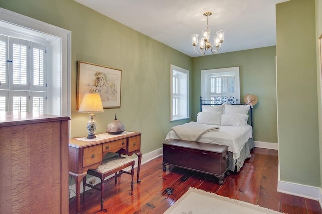 bedroom featuring dark hardwood / wood-style floors and a chandelier