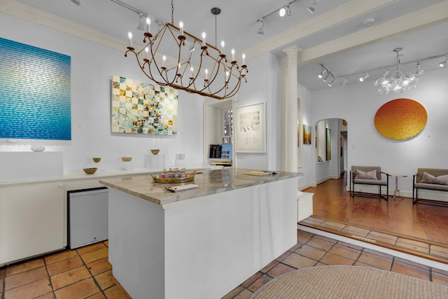 kitchen with light hardwood / wood-style flooring, decorative light fixtures, a center island, and white cabinets