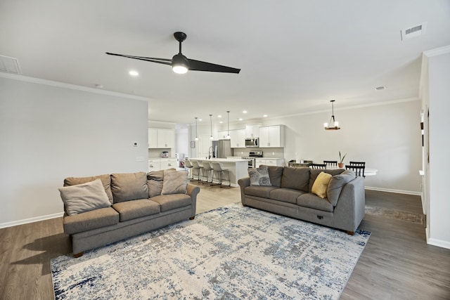 living room featuring crown molding, ceiling fan, and light hardwood / wood-style flooring