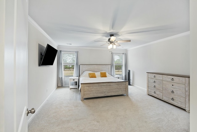 carpeted bedroom featuring crown molding and ceiling fan