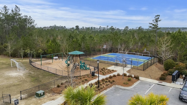 view of swimming pool with tennis court and a playground