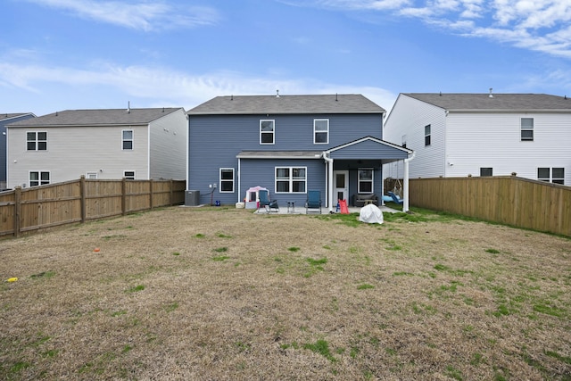 rear view of property with a yard, central AC, and a patio area