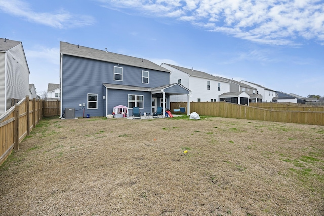 rear view of house featuring a yard, a patio area, and central air condition unit