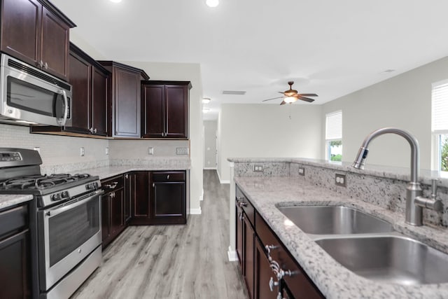 1510 Royal Colony Rd, Johns Island, SC 29455 - kitchen with stainless steel appliances, a sink, a ceiling fan, light wood-style flooring, and backsplash