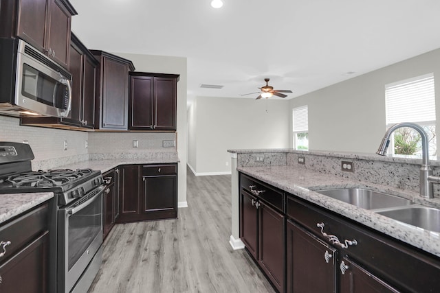 1510 Royal Colony Rd, Johns Island, SC 29455 - kitchen with appliances with stainless steel finishes, a sink, light wood-type flooring, a ceiling fan, and backsplash