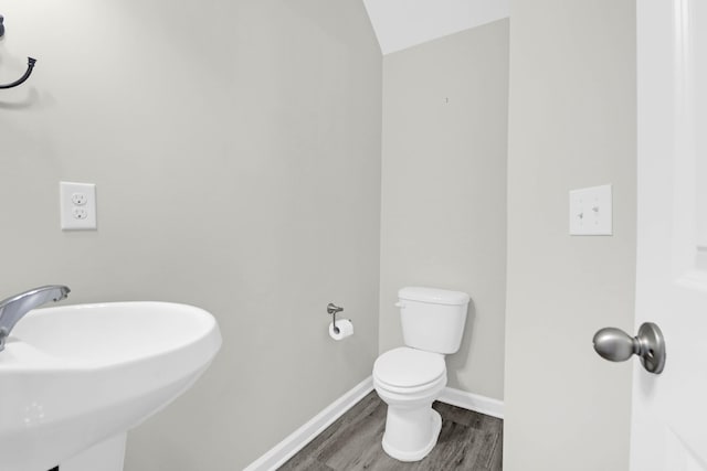 1510 Royal Colony Rd, Johns Island, SC 29455 - half bath with a sink, toilet, wood finished floors, baseboards, and vaulted ceiling