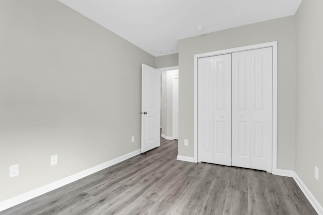 1510 Royal Colony Rd, Johns Island, SC 29455 - unfurnished bedroom featuring wood finished floors, a closet, and baseboards