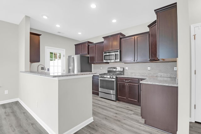 1510 Royal Colony Rd, Johns Island, SC 29455 - kitchen featuring appliances with stainless steel finishes, light wood finished floors, decorative backsplash, a peninsula, and recessed lighting