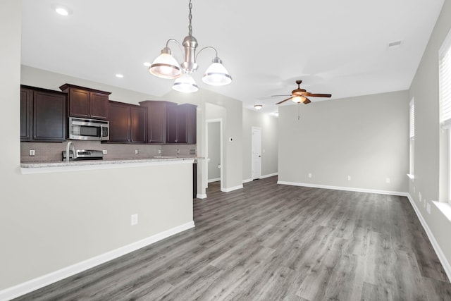1510 Royal Colony Rd, Johns Island, SC 29455 - kitchen featuring stainless steel microwave, ceiling fan, tasteful backsplash, a chandelier, and wood finished floors
