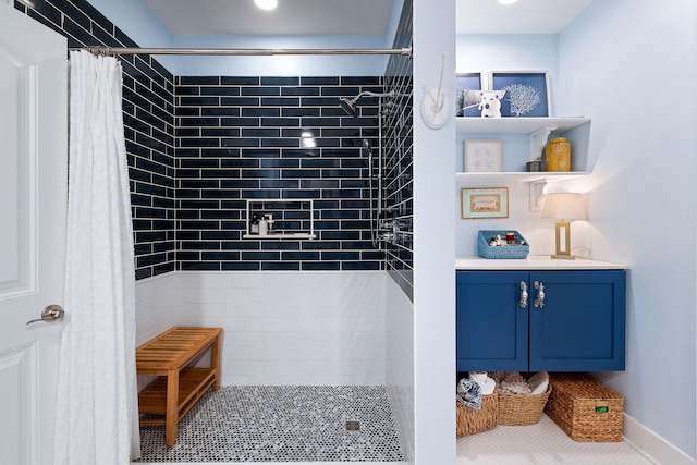 bathroom featuring vanity and a tile shower