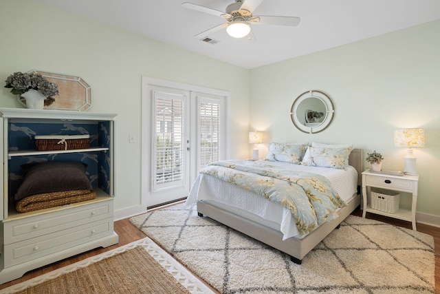 bedroom with visible vents, wood finished floors, access to exterior, baseboards, and ceiling fan